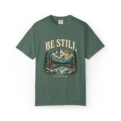 Blue Spruce Comfort Colors 1717 T-shirt with Be Still mountain, lake, pine trees, and Psalm 46:10 front graphic.
