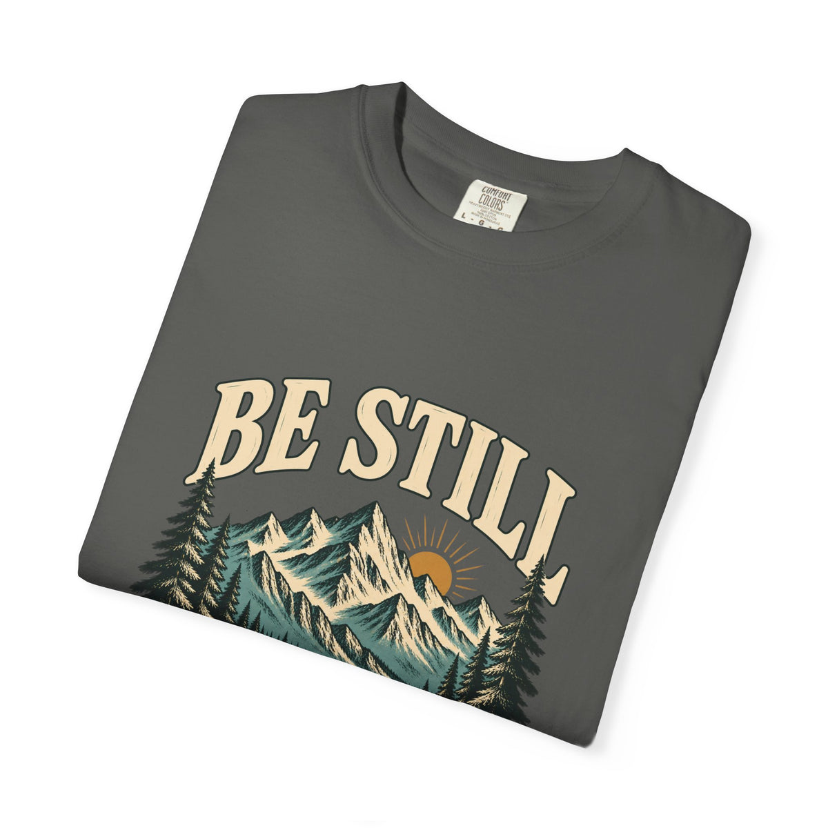Folded Pepper Be Still mountain T-shirt showing the front artwork and Comfort Colors label.