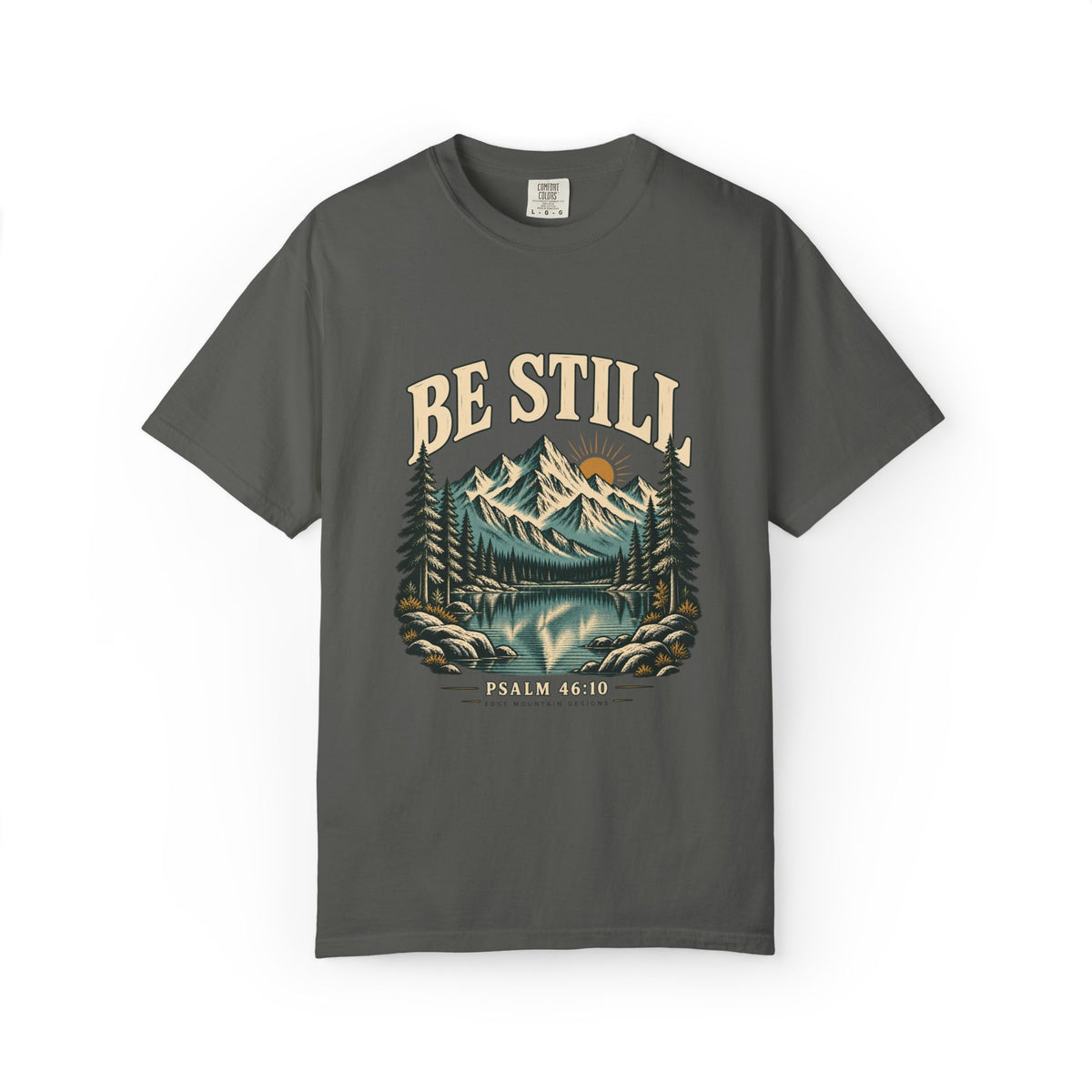 Pepper Comfort Colors 1717 T-shirt with Be Still mountain, lake, pine trees, and Psalm 46:10 front graphic.