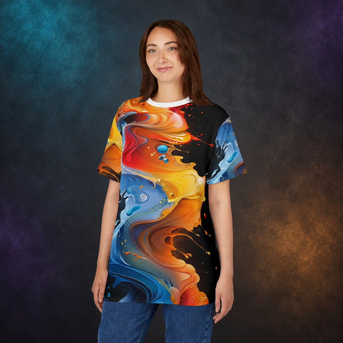 Woman wearing the abstract fluid art all-over print T-shirt against a charcoal studio background with teal and amber lighting.