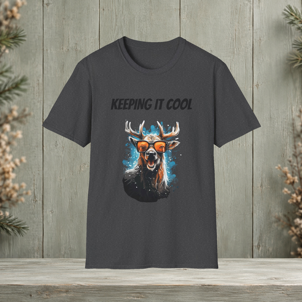 Dark heather Keeping It Cool T-Shirt front view with original antler artwork on a muted woodland background.